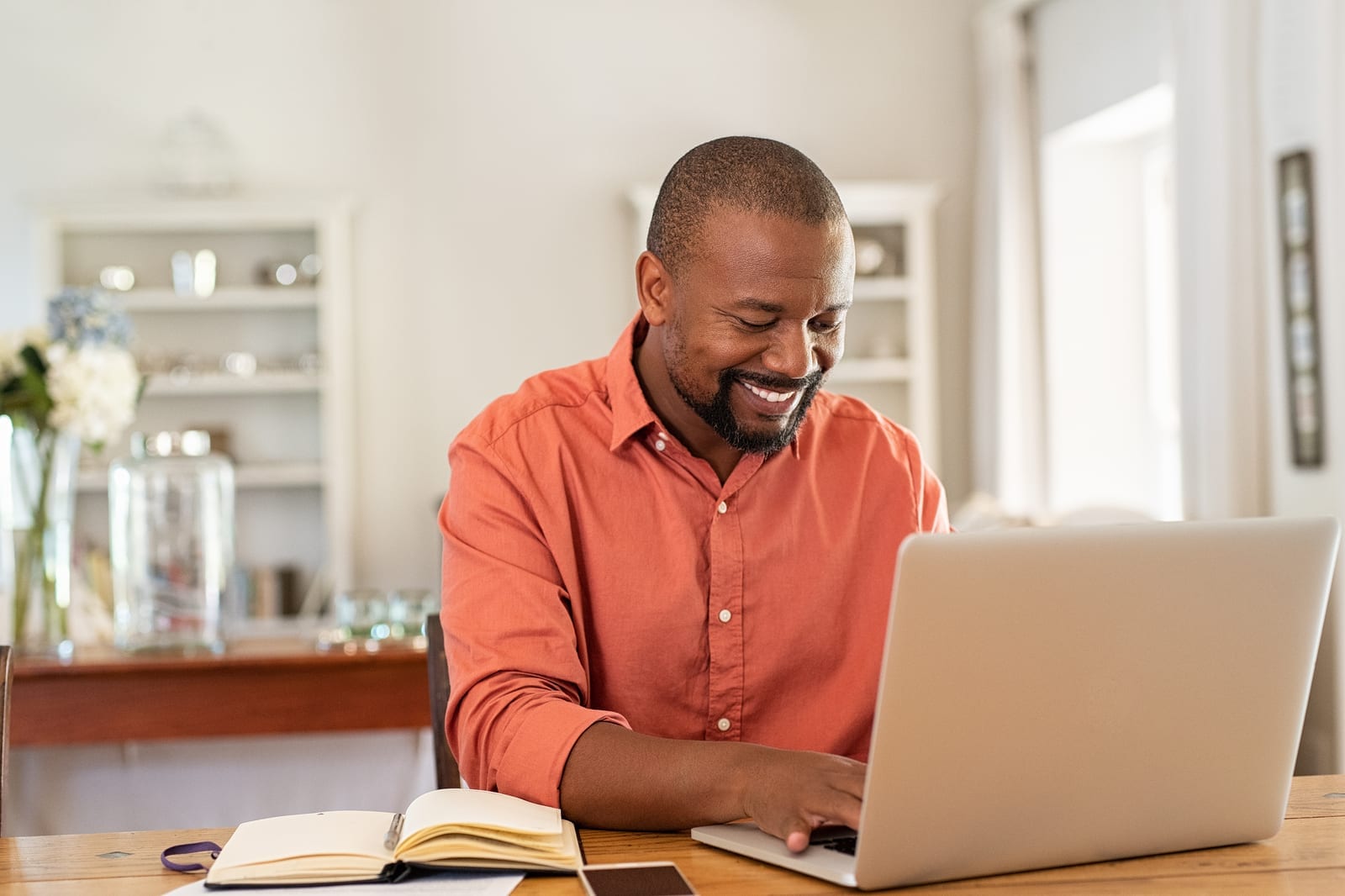 bigstock-Smiling-black-man-using-laptop-306851869